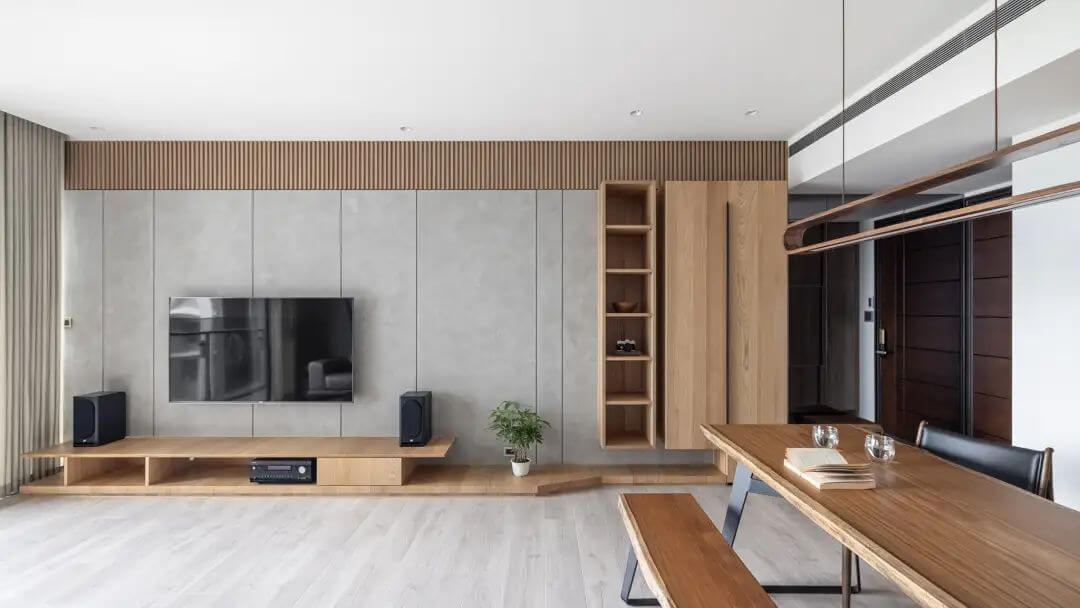 This image showcases a pristine and modern interior that artfully integrates the Extended Collection's concrete-style laminates, providing a sleek and urban backdrop to the living area.