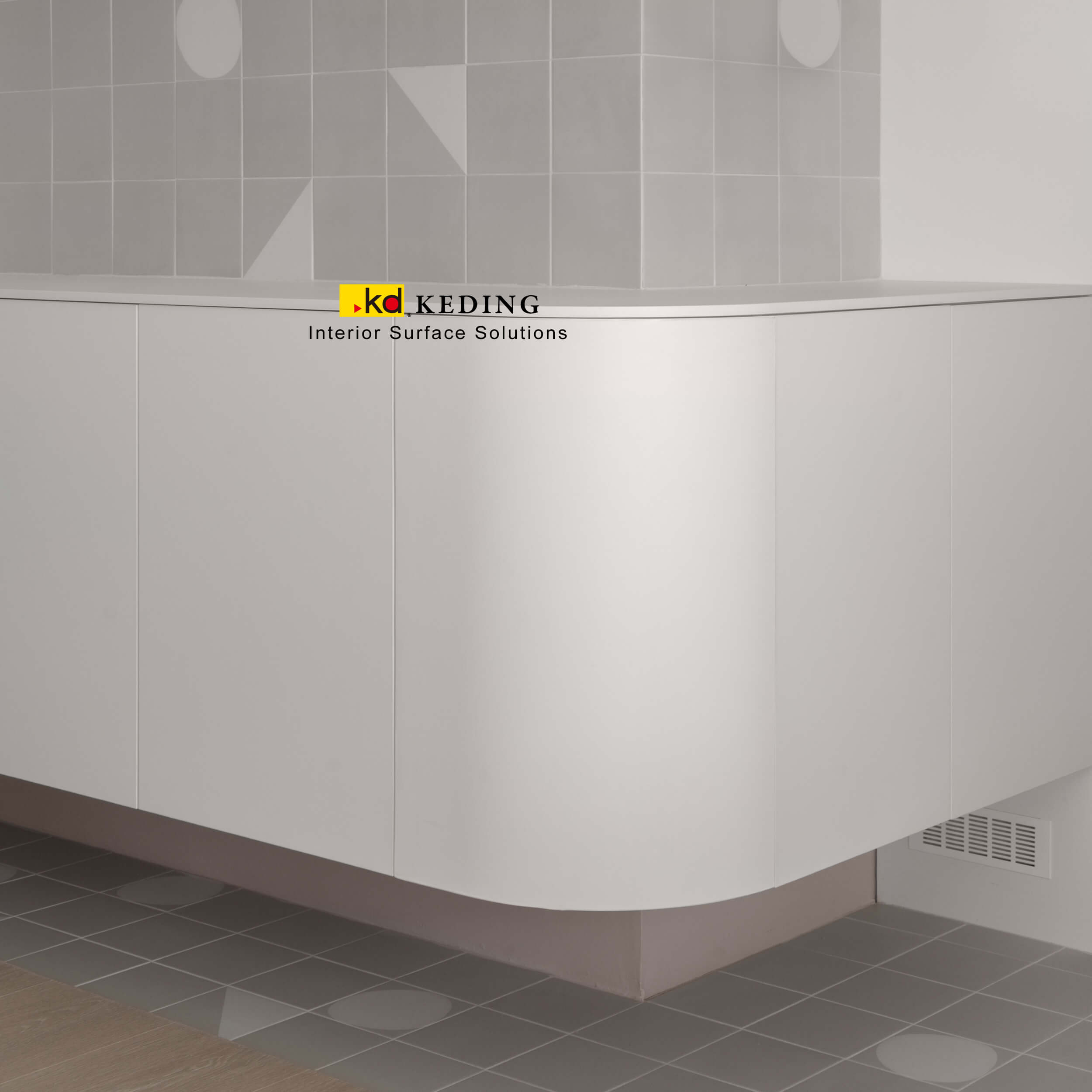 A close-up view of sleek, curved cabinets finished in KD ECO⁺ laminates, blending seamlessly with minimalist tile patterns